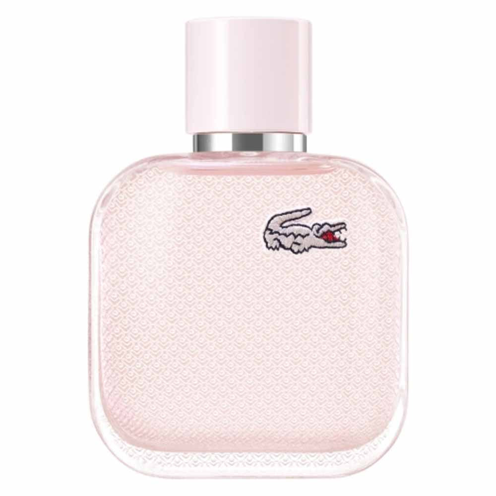 Pink Lacoste perfume bottle on a white background