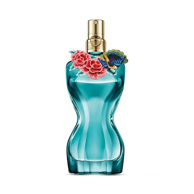 Blue perfume bottle with floral design on a white background