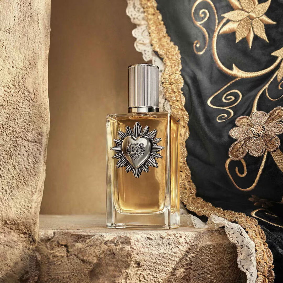 Perfume bottle with decorative heart design on a textured surface