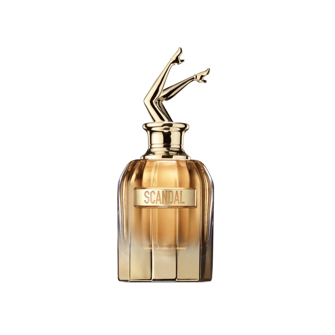 Perfume bottle with gold cap and 'Scandal' label on a white background